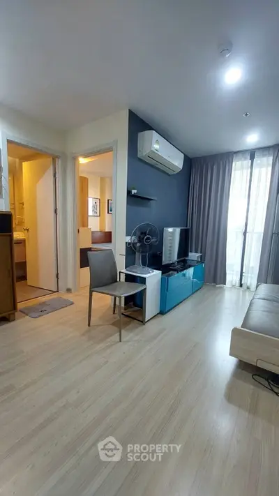 Modern living room with sleek design, featuring air conditioning and stylish furniture, perfect for urban living.