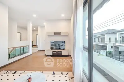Spacious modern living room with large windows and stylish decor.