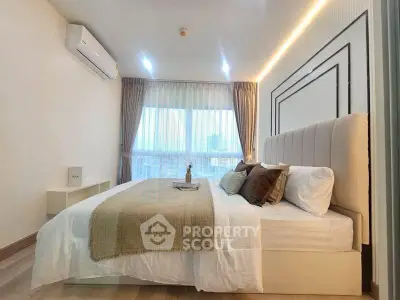 Luxurious bedroom with elegant decor and large window offering city views