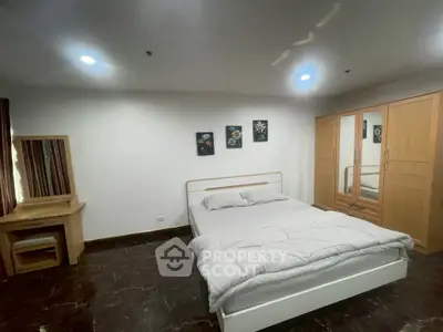 Spacious bedroom with modern furniture and elegant decor