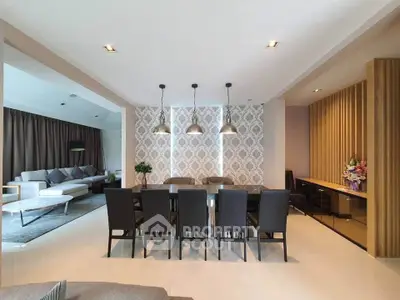 Luxurious open-plan living and dining area with elegant decor and modern lighting.