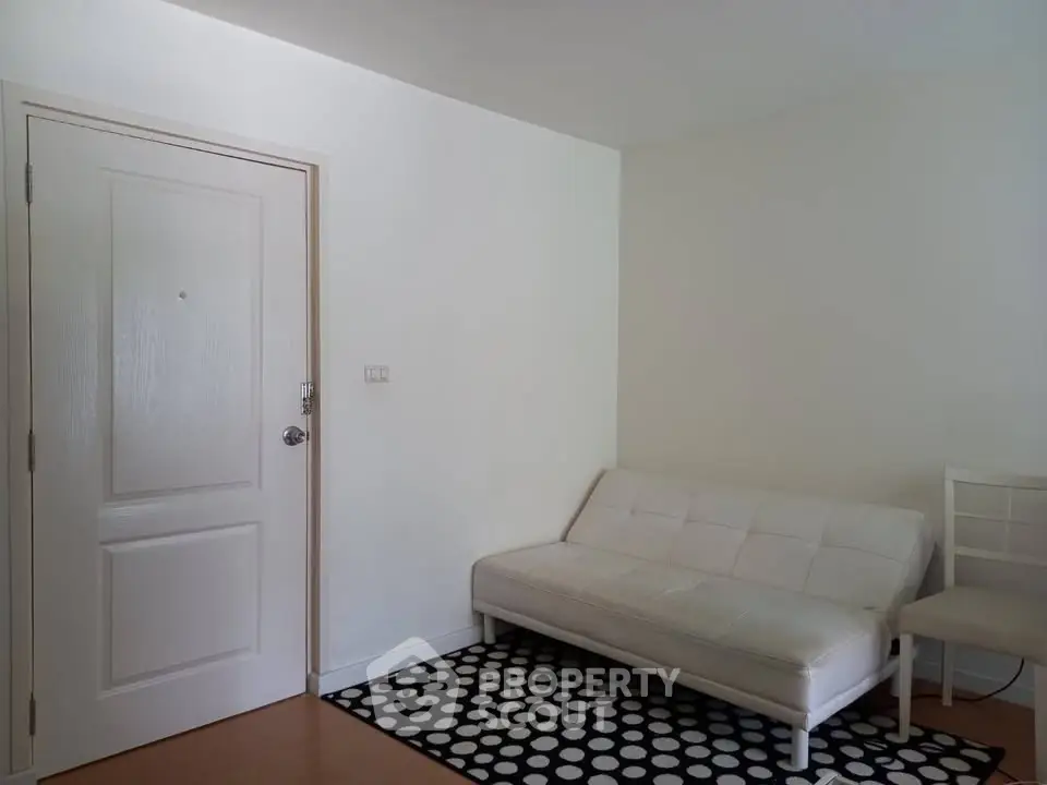 Minimalist living room with white sofa and polka dot rug