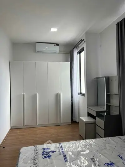 Modern bedroom with sleek wardrobe and air conditioning unit