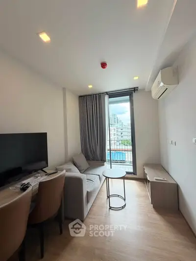Modern living room with sleek furniture and city view balcony in a stylish apartment.
