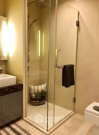 Elegant bathroom with glass shower enclosure and modern fixtures