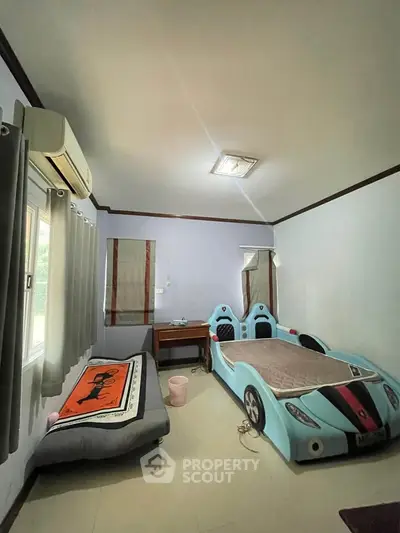 Charming children's bedroom with car-themed bed and cozy decor