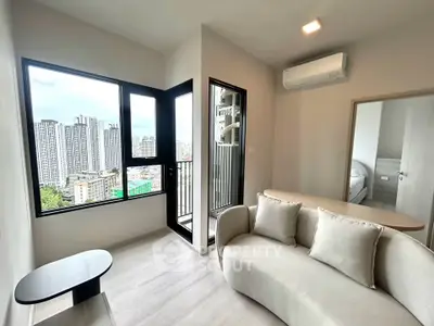 Modern living room with city view and balcony access in high-rise apartment