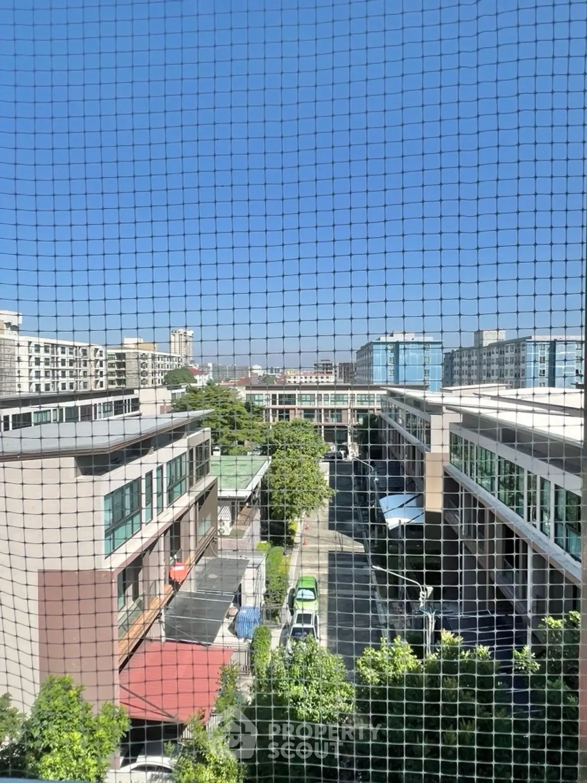 Urban view from a high-rise building showcasing modern architecture and cityscape.