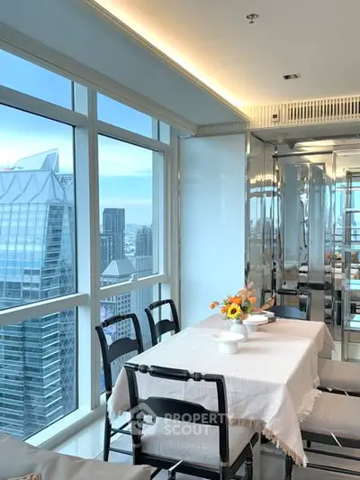 Stunning high-rise dining area with panoramic city views and elegant decor.