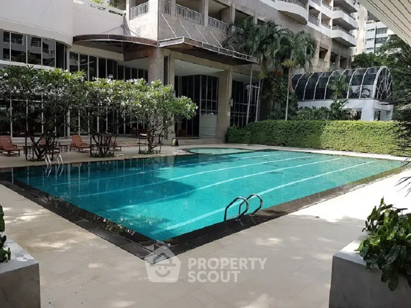 Luxurious condominium with stunning outdoor pool and lush greenery