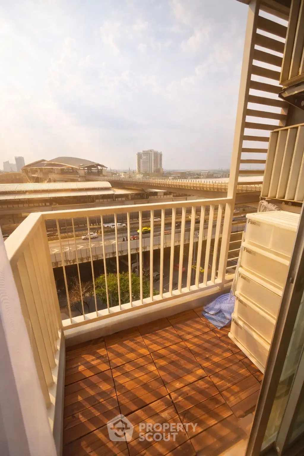 Charming balcony with city view and wooden flooring, perfect for relaxation and enjoying urban scenery.