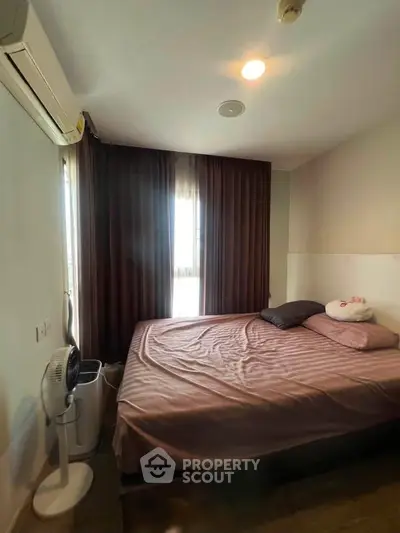 Cozy bedroom with soft lighting and modern decor, featuring a comfortable bed and air conditioning.