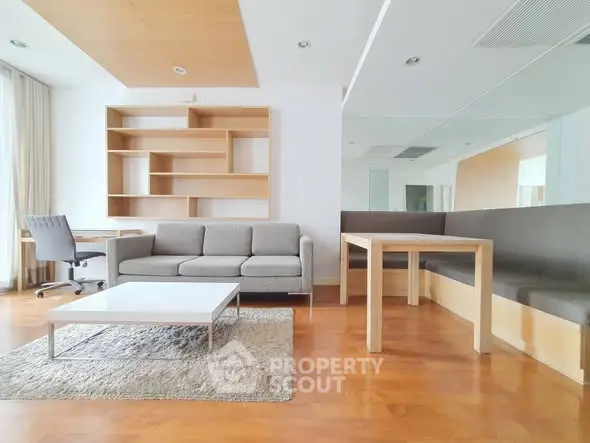 Spacious modern living room with stylish furniture and wooden flooring