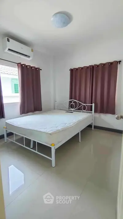 Cozy bedroom with natural light and modern air conditioning unit