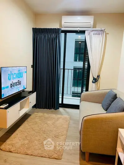 Cozy living room with modern decor and balcony access in a stylish apartment.