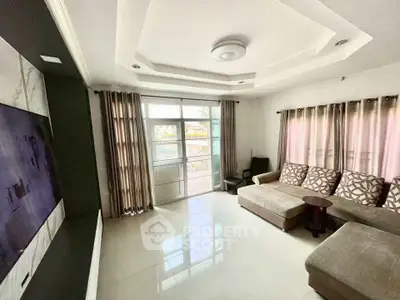 Spacious living room with modern decor and large windows for natural light