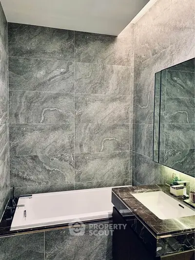 Luxurious modern bathroom with elegant marble tiles and sleek fixtures.