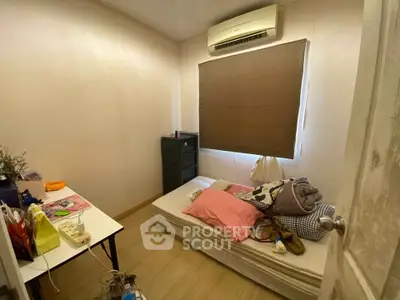 Cozy bedroom with air conditioning and minimalist decor, perfect for a comfortable living space.