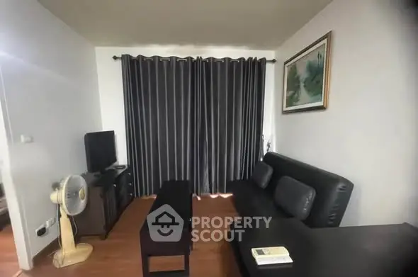 Cozy living room with modern decor and dark curtains