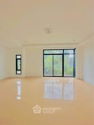 Spacious empty room with large windows and natural light