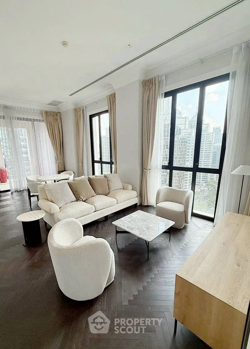 Luxurious living room with modern furniture and stunning city view through large windows.