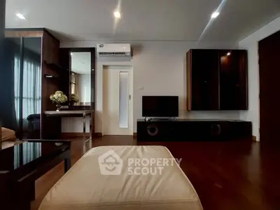 Modern living room with sleek furniture and ambient lighting, perfect for relaxation and entertainment.