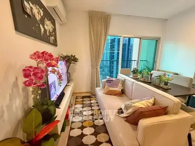 Stylish living room with modern decor and city view balcony in high-rise apartment.
