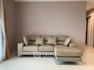 Modern living room with elegant beige sectional sofa and minimalist decor
