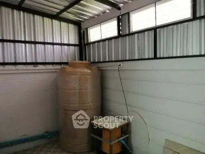 Utility room with water tank and tiled floor in modern home