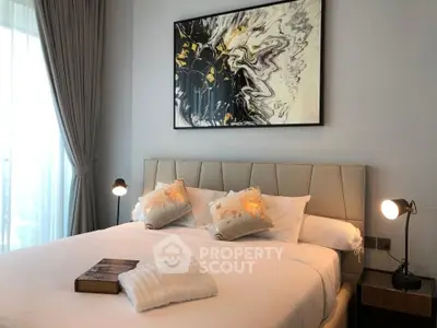 Luxurious bedroom with elegant decor and modern art piece above bed
