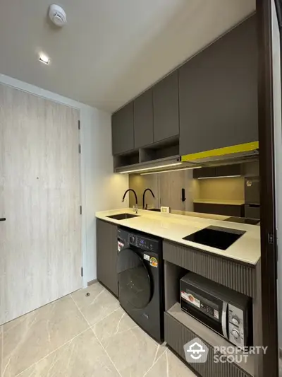 Modern compact kitchen with sleek appliances and stylish cabinetry