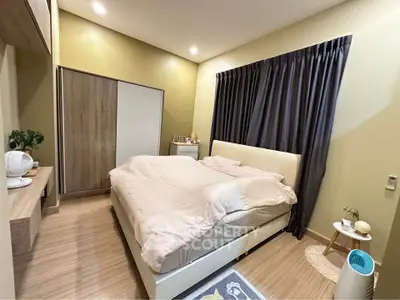 Cozy bedroom with modern decor and ample storage space, featuring a comfortable bed and stylish curtains.