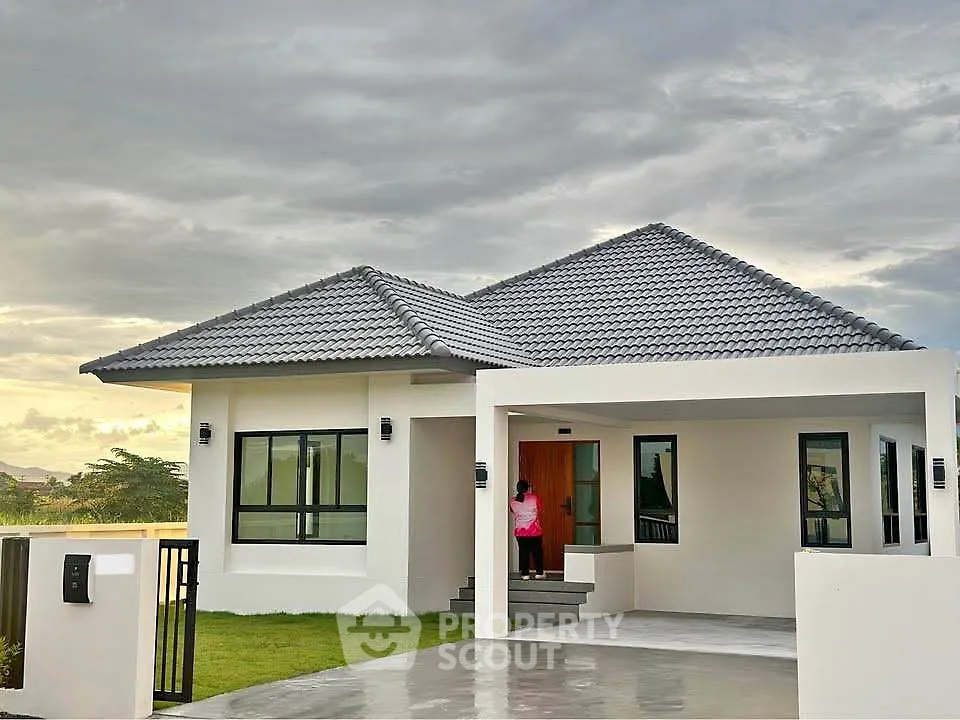 Modern single-story home with sleek design and spacious driveway, perfect for family living.