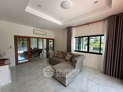 Spacious living room with elegant sofa and large windows in modern home