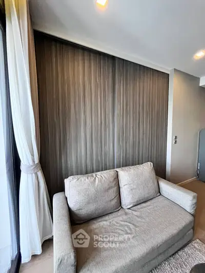 Modern living room with cozy sofa and elegant wooden wall paneling