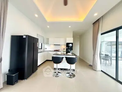 Modern kitchen with sleek design, featuring an island and high-end appliances, perfect for culinary enthusiasts.