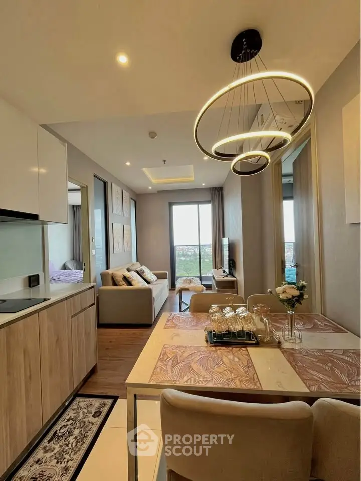 Modern open-plan living room with stylish lighting and cozy decor