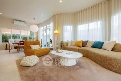 Spacious living room with modern decor and large windows for natural light.