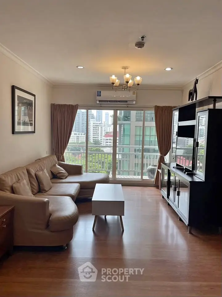 Spacious living room with modern furniture and city view, perfect for urban living.