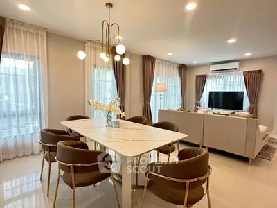 Luxurious open-plan living and dining area with elegant lighting and modern furnishings.