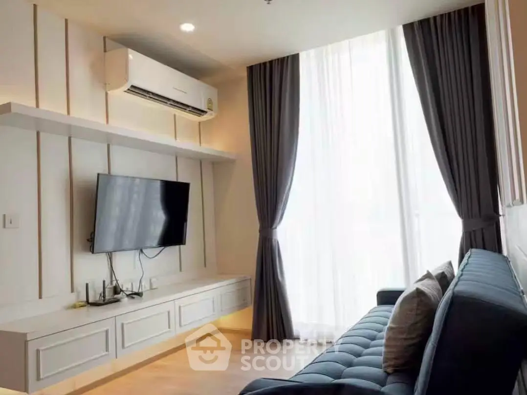 Modern living room with sleek design, featuring a wall-mounted TV and stylish sofa.
