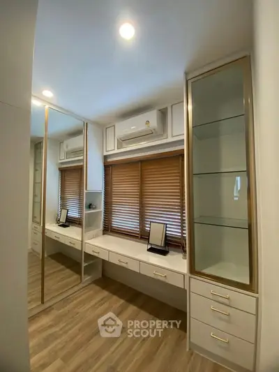 Elegant study room with built-in desk and mirrored closet, perfect for productivity.
