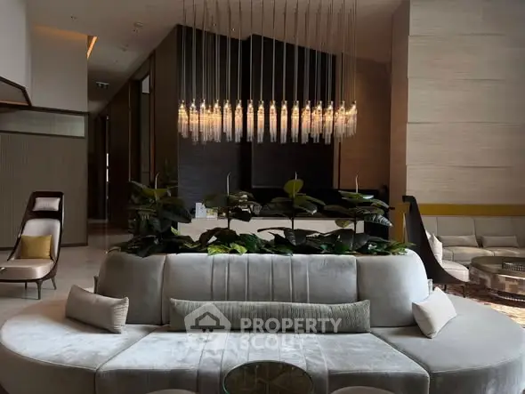 Luxurious modern living room with elegant chandelier and plush seating in upscale apartment.