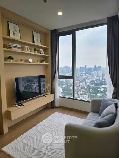 Modern living room with large window offering stunning city view, cozy sofa, and stylish decor.