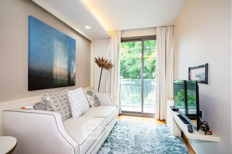Chic living room with modern decor and balcony view, perfect for urban living.