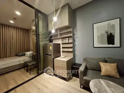 Modern studio apartment with sleek design, featuring cozy living area and compact kitchen.