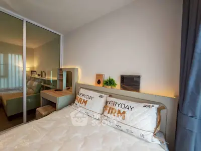 Modern bedroom with stylish decor and mirrored closet doors, featuring cozy bedding and ambient lighting.
