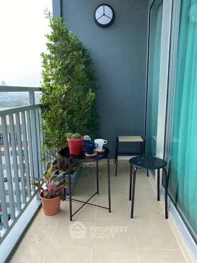 Charming balcony with potted plants and modern furniture, perfect for relaxation.