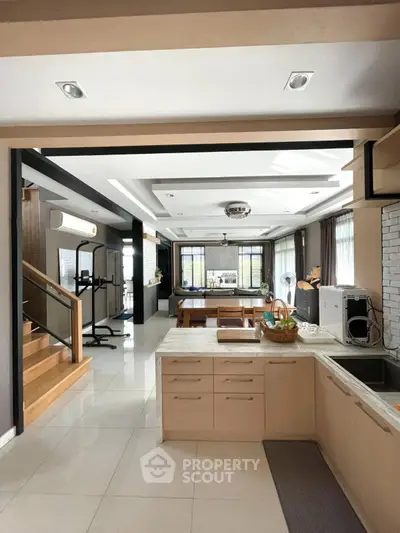 Spacious open-layout kitchen with modern appliances and dining area, perfect for family gatherings.