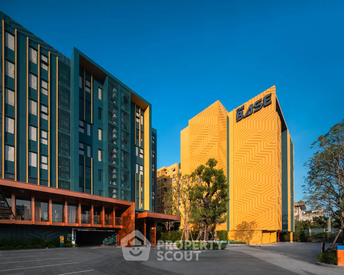 Modern vibrant apartment complex with striking architecture and lush landscaping.